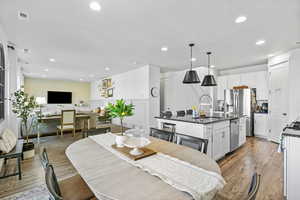 Dining space with light wood-type flooring and recessed lighting