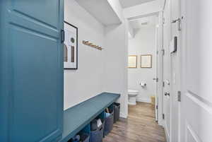 Mudroom featuring wood finished floors and baseboards