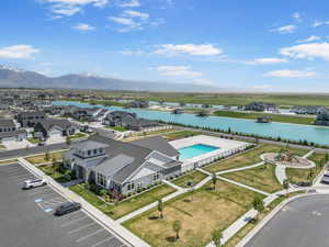 Aerial view of residential area with a nearby body of water and a pool