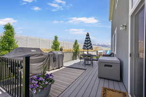 Trex deck featuring outdoor dining area, seating, and a grill