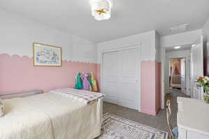 Carpeted bedroom with a closet