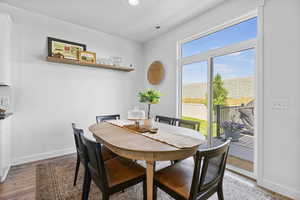 Dining room with light wood finished floors and recessed lighting