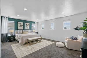 Primary bedroom featuring  recessed lighting, and lots of windows for natural sunlight