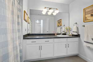 Full bathroom featuring tile patterned flooring, & vanity