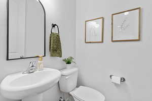 Half bathroom with a sink and toilet