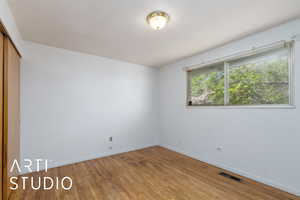 Spare room featuring light wood finished floors and baseboards