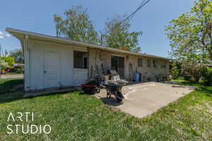 Back of property featuring a patio and brick siding