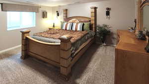 Bedroom featuring carpet and baseboards