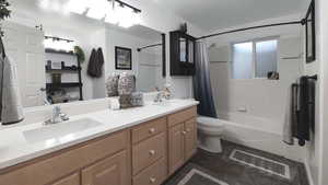 Full bath with shower / tub combo with curtain, toilet, double vanity, and tile patterned flooring