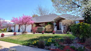Ranch-style home featuring a garage, brick siding, concrete driveway, and roof with shingles