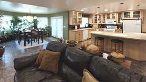 Living area featuring plenty of natural light, recessed lighting, and dark stone finish flooring