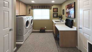 Clothes washing area featuring cabinet space, washer and clothes dryer, recessed lighting, and baseboards