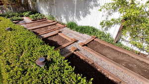 Exterior view of a vegetable garden and fence