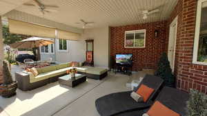 View of patio featuring a ceiling fan, an outdoor living space, and a grill