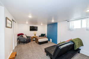 Carpeted living room with recessed lighting