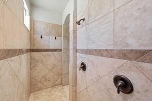 Bathroom featuring a tile shower