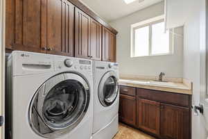 Washroom with cabinet space and independent washer and dryer