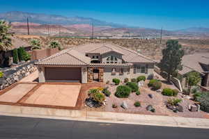 Mediterranean / spanish-style house with a mountain view, a garage, stucco siding, and a tile roof