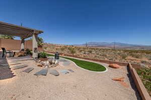 View of yard with a mountain view, a pergola, a patio, and fence