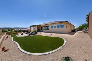 Rear view of property with a patio area, a pergola, a tile roof, stucco siding, and a mountain view
