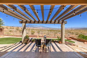 View of patio / terrace featuring a mountain view, a pergola, and a view of countryside