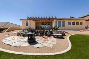 Rear view of house featuring a tile roof, a pergola, a patio area, and stucco siding