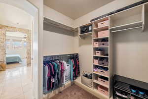 Walk in closet featuring tile patterned flooring