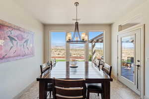 Dining area with a chandelier, baseboards, and a mountain view