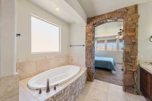Full bathroom with vanity, tile patterned floors, ensuite bathroom, a whirlpool tub, and ceiling fan