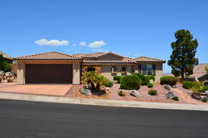 Mediterranean / spanish house featuring stucco siding, an attached garage, concrete driveway, and a tile roof