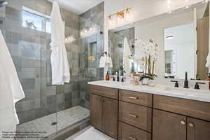 Bathroom with double vanity and a stall shower
