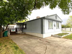 View of front facade featuring a patio and fence