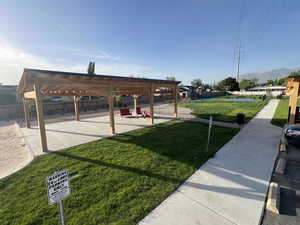 Dock area featuring a mountain view, a patio, and a pergola