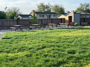 View of yard with a storage unit and an outbuilding