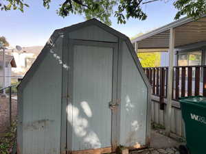 View of shed featuring fence