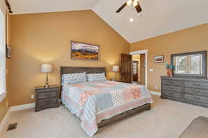 Carpeted bedroom with baseboards, high vaulted ceiling, and a ceiling fan
