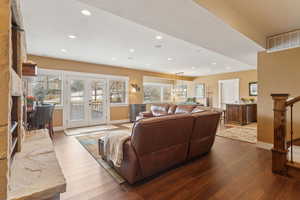 Living area with wood finished floors, baseboards, recessed lighting, and french doors