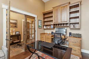 Office area with dark wood finished floors and baseboards