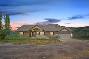 View of front of house featuring concrete driveway and an attached garage