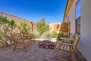 View of patio with a fenced backyard and a fire pit