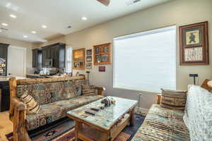 Living area featuring recessed lighting, plenty of natural light, and baseboards