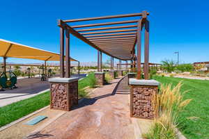View of home's community with a pergola, a mountain view, and a yard