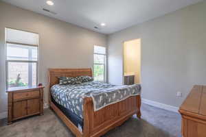 Bedroom featuring carpet flooring, baseboards, ensuite bathroom, and recessed lighting