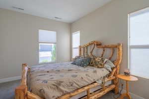 Carpeted bedroom featuring baseboards