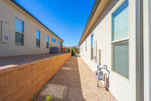 View of home's exterior featuring stucco siding and cooling unit
