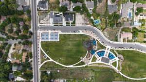 Aerial view of property and surrounding area featuring nearby suburban area
