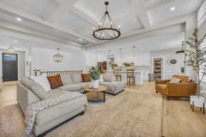 Living room featuring a chandelier, light wood-type flooring, recessed lighting, and beam ceiling