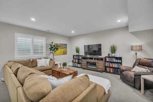 Living area with carpet floors and recessed lighting
