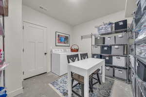 Office space with separate washer and dryer and concrete flooring