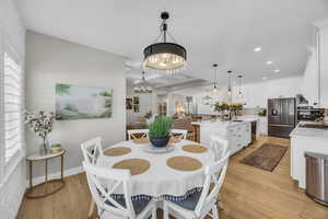 Dining area with light wood-style floors, a chandelier, and recessed lighting